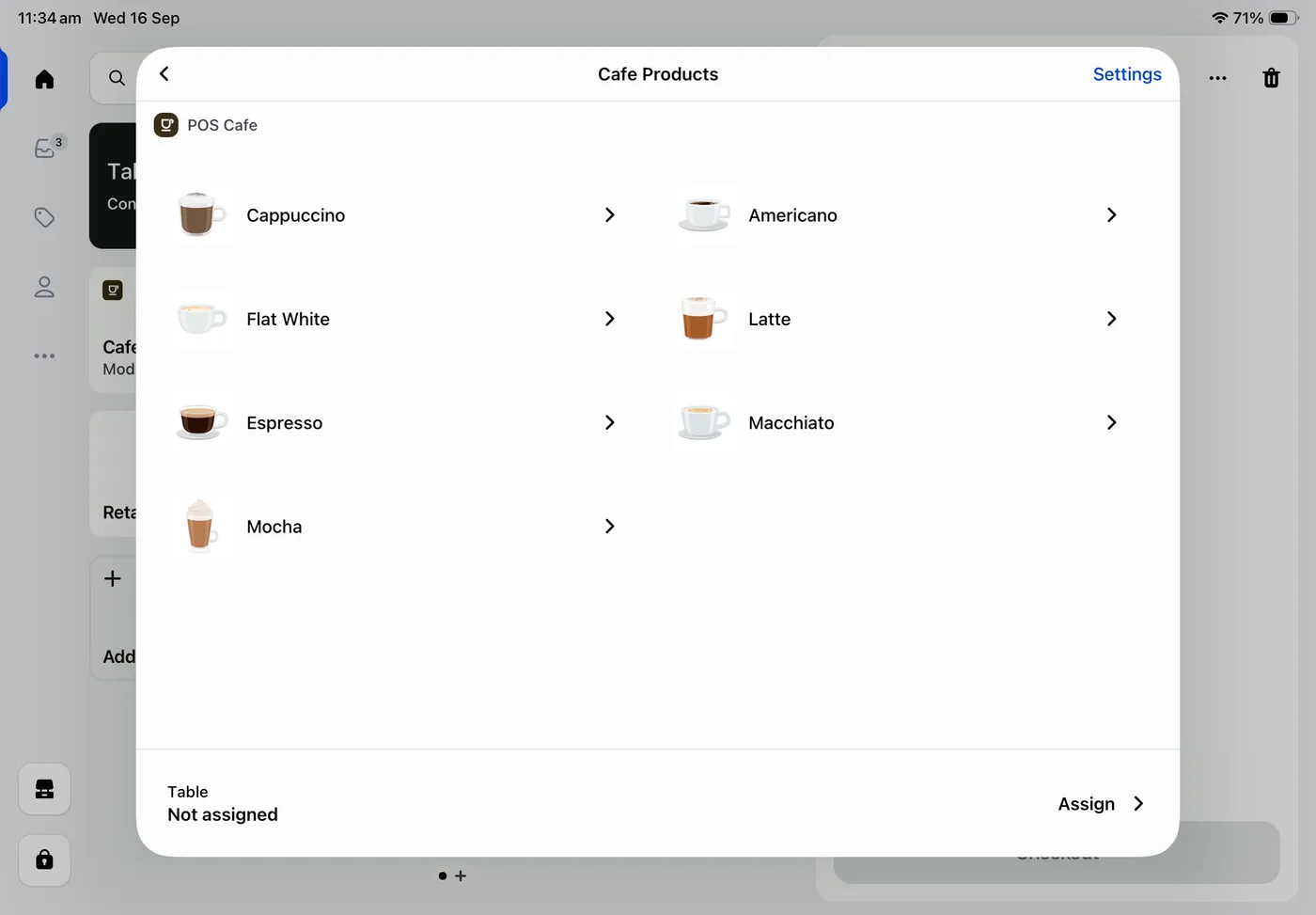 The POS Cafe tile in Shopify POS on iPad, listing cafe products such as Cappuccino, Flat White and Latte, with a Table bar to assign the order to a table
